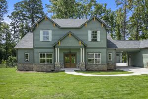 a house with a driveway and a lawn