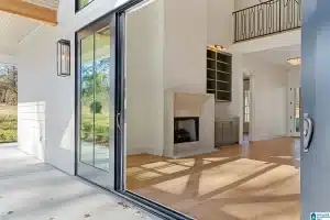 a room with a glass door and a fireplace