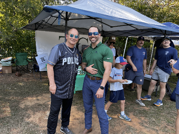two men standing under a tent