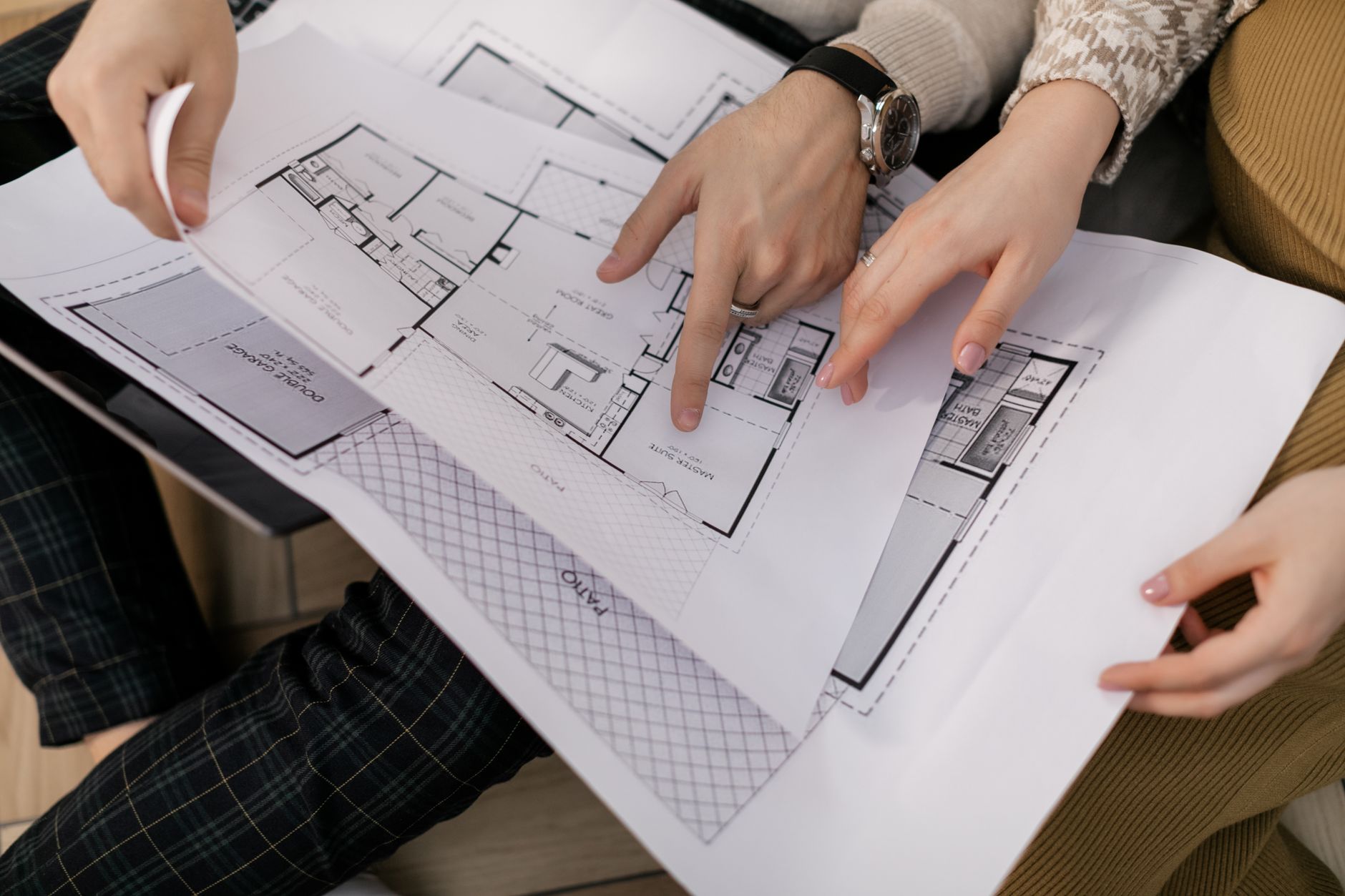 hands holding sketches of house project
